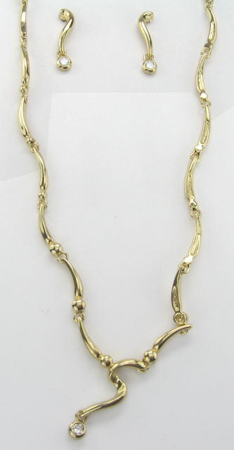 Gold earring and necklace set featuring S Link design and crystal embellishments, perfect for elegance and versatility.