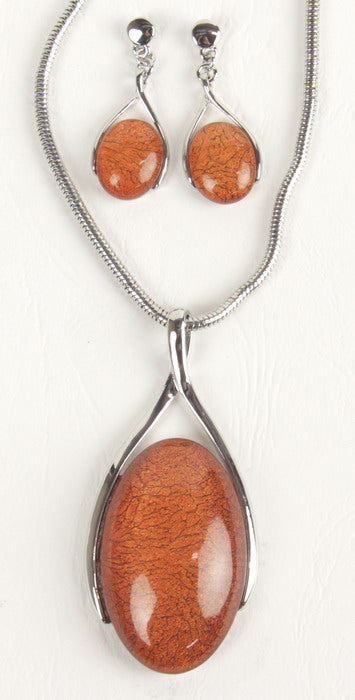 Vibrant orange resin earring and necklace set with silver swirl design, perfect for stylish versatility and elegant outfits.