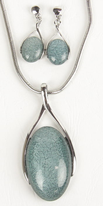 Elegant teal resin earring and necklace set with silver swirl design, perfect for casual or formal occasions.