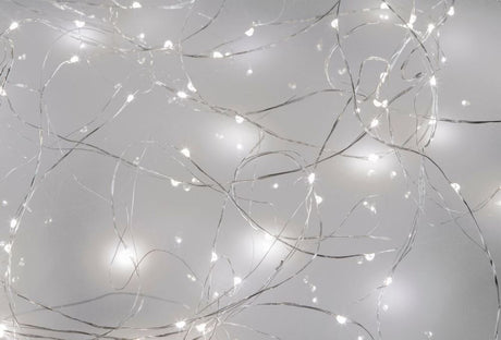 Cool white LED seed lights on silver wire, 10M long with 100 energy-efficient bulbs for enchanting indoor decor.