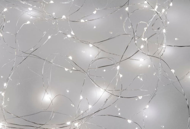 Cool white LED seed lights on silver wire, 10M long with 100 energy-efficient bulbs for enchanting indoor decor.
