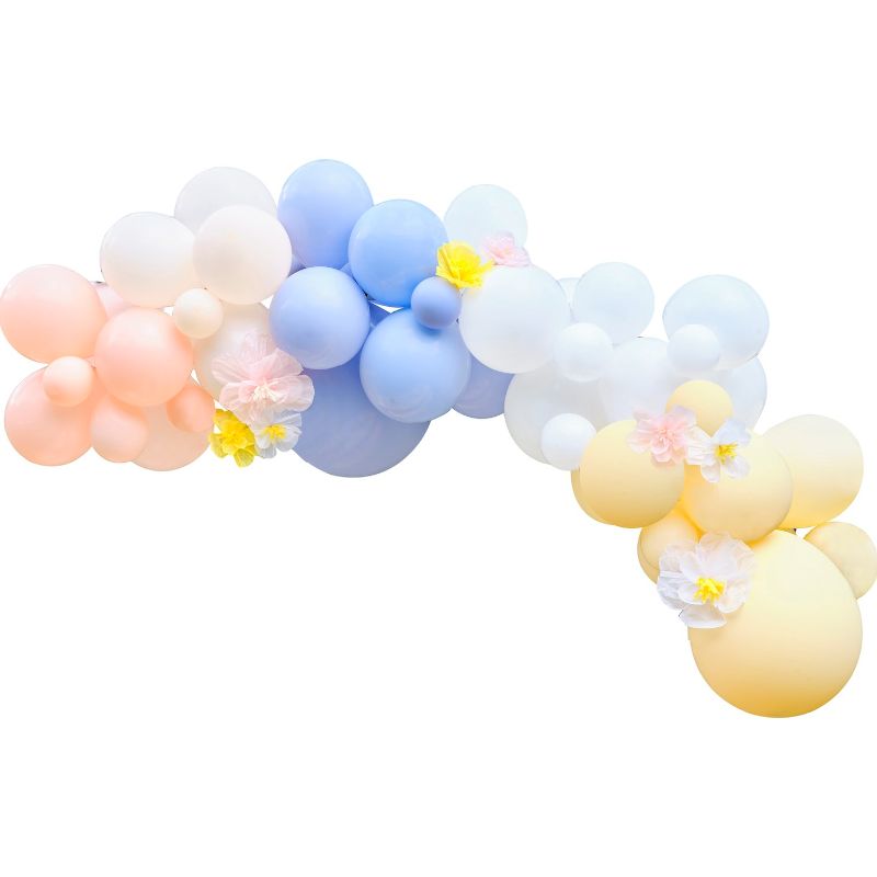 Pastel balloon arch adorned with tissue paper flowers, perfect for spring parties and photo backdrops.