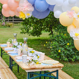 Pastel balloon arch with tissue paper flowers, perfect for spring events, featuring 60 balloons and easy assembly tools.