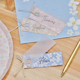 Elegant floral place cards made of vellum paper, perfect for weddings and events, featuring pastel colors and cream twine.