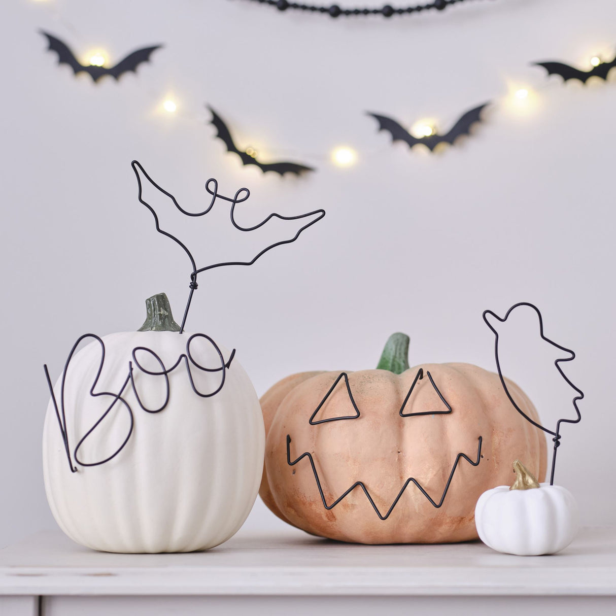 Stylish eco-friendly wire pumpkin decorations, featuring bat, ghost, boo, and pumpkin face designs for Halloween decor.