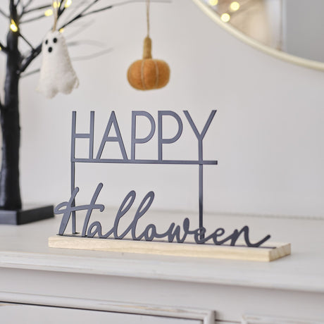 Black metal "Happy Halloween" sign with wooden base, perfect for modern Halloween decor on mantels or shelves.