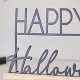 Stylish black metal "Happy Halloween" sign with wooden base, perfect for contemporary Halloween decor.