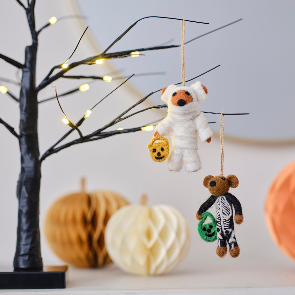 Handmade felt Mummy Bear decoration for Halloween, featuring pumpkin spice color and twine loop for easy hanging.