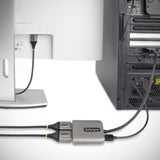 DisplayPort MST Hub by StarTech connecting two monitors, supports 4K at 60Hz, HDR, and plug-and-play setup.