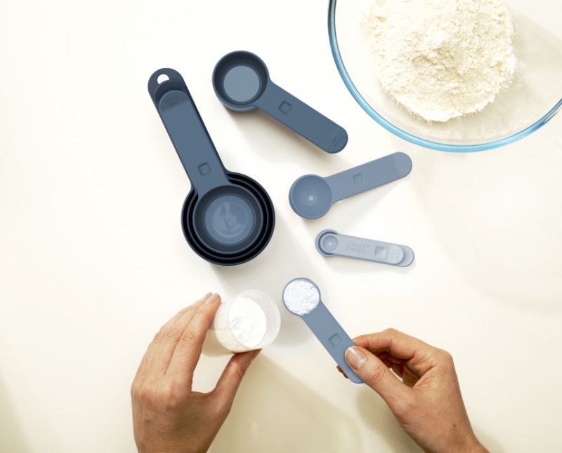 8-piece Nest Measuring Cups Sky set by Joseph Joseph, featuring stacked design and snap-together handles for efficient storage.