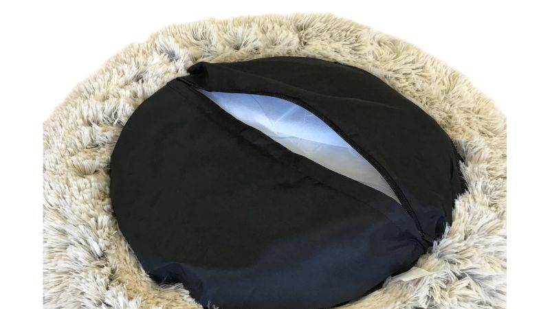 Cozy caramel latte doughnut-shaped pet bed for small pets, featuring a supportive rim and soft padded center for relaxation.