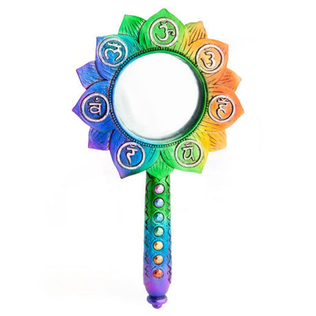 Lotus-shaped hand mirror with chakra symbols, vibrant metallic finish, and gem-encrusted handle for balance and beauty.