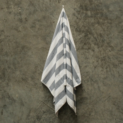 Grey and white striped pool towel measuring 75 x 150 cm, plush 420gsm, made of 80% cotton for softness and durability.