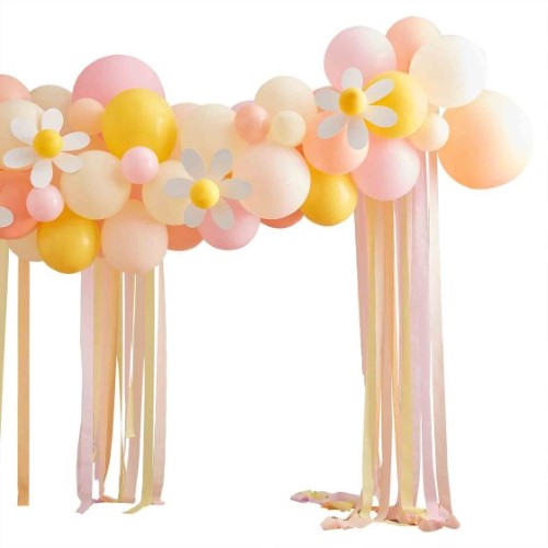 Colorful Easter balloon arch with peach, yellow, and pink balloons, adorned with daisies and crepe streamers for festive decor.