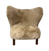 Luxurious Sherpa armchair with plush fabric, sturdy wooden frame, ideal for cozy living rooms and stylish decor.