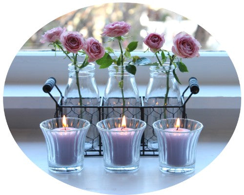Clear glass tea light holder with shot flared shape, measuring 8cm diameter and 7cm height, perfect for any decor.