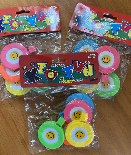 Colorful party favor whistles with a cheerful smile design, great for festive celebrations and fun for all ages.
