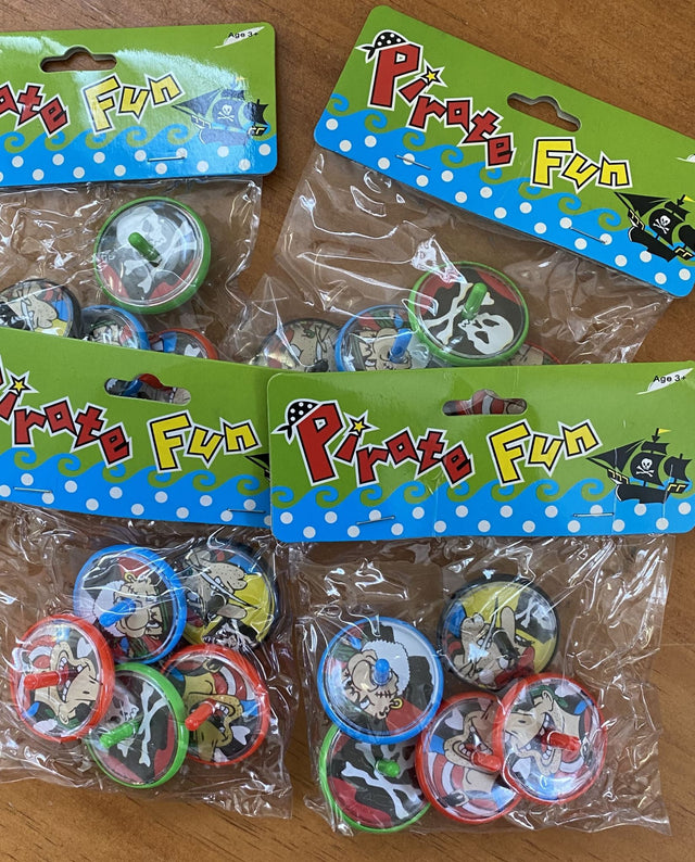 Colorful pirate-themed spinning tops in 4 packs, perfect for party favors or loot bags at kids' pirate parties.