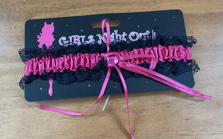Hot pink hen's party garter, a vibrant and playful accessory perfect for bachelorette celebrations and photo opportunities.