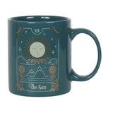 Ceramic mug featuring The Sun tarot design in green, white, and gold, with 350ml capacity, microwave and dishwasher safe.