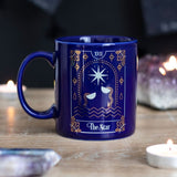 Ceramic mug featuring the "Star" tarot design in white and gold on a deep blue background, 350ml capacity.