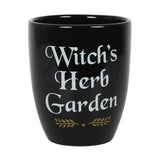 Ceramic plant pot with 'Witch's Herb Garden' text and leaf design, perfect for growing magical herbs indoors.