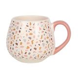 Terrazzo print ceramic mug with pastel speckles and pink handle, perfect for hot beverages and modern decor.