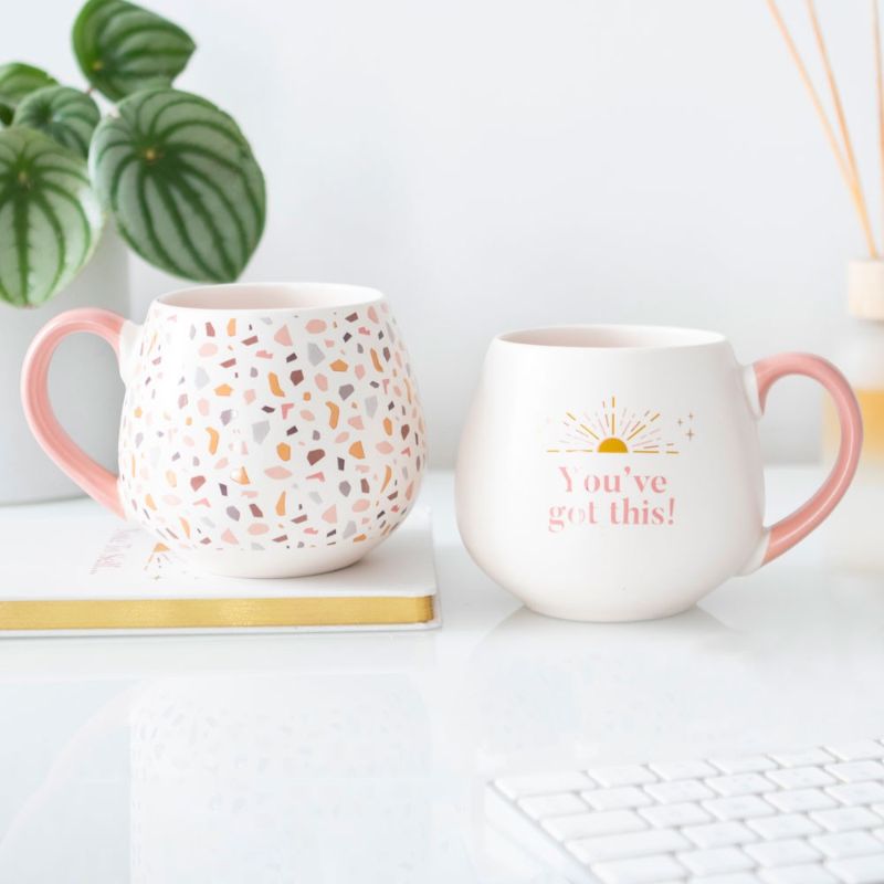 Terrazzo print ceramic mug with pastel colors and a pink handle, perfect for hot beverages and modern home decor.