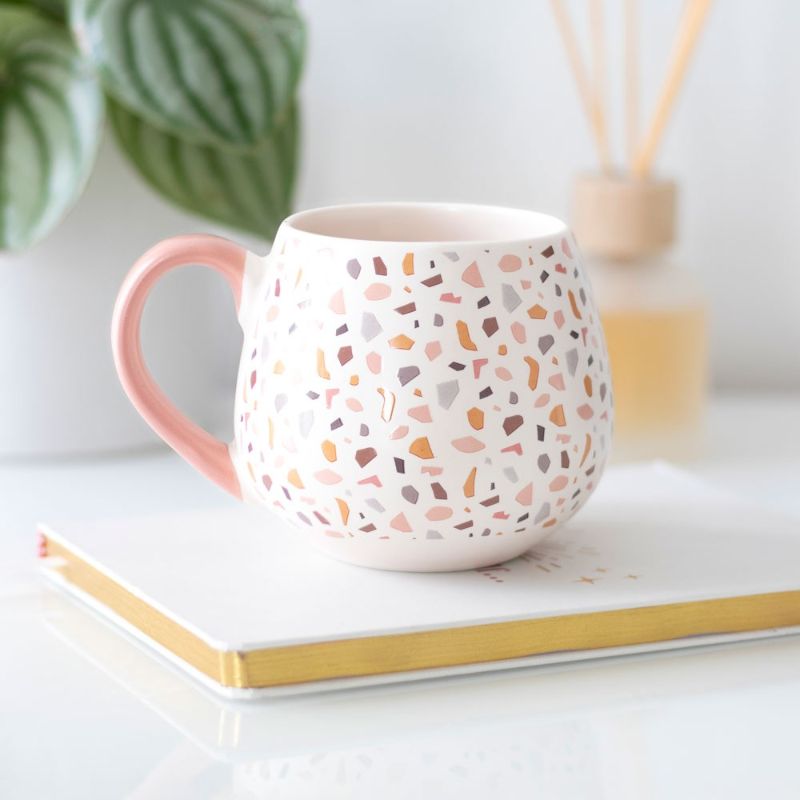 Terrazzo print ceramic mug with pastel speckles, rounded shape, and pink handle, perfect for modern home decor and gifts.