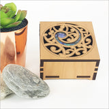 Elegant square trinket box featuring paua inlays, crafted from NZ veneer; perfect for storing keepsakes.