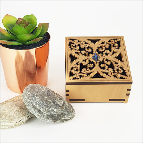 Elegant small square trinket box made from NZ veneer with a stunning paua inlaid design, ideal for jewelry storage.