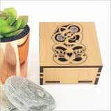 Square trinket box with paua inlays, crafted from NZ veneer, ideal for storing jewelry and keepsakes.