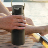 Stylish black vacuum bottle with Bluetooth speaker, keeps drinks hot/cold, perfect for outdoor adventures or daily use.