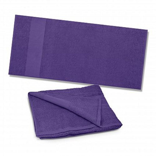 Vibrant purple Dune Beach Towel made from soft, absorbent cotton, perfect for beach days and picnics.