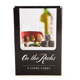 Whisky Stones set with 9 granite cubes for chilling drinks without dilution, packaged in a sleek black velvet pouch.