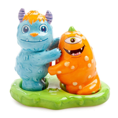 Cute ceramic salt and pepper shakers designed as Monsterlings, complete with a green slime holder for display.