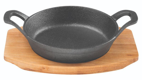 Round 12cm cast iron gratin dish with accompanying oval tray, perfect for baking, roasting, and individual servings.