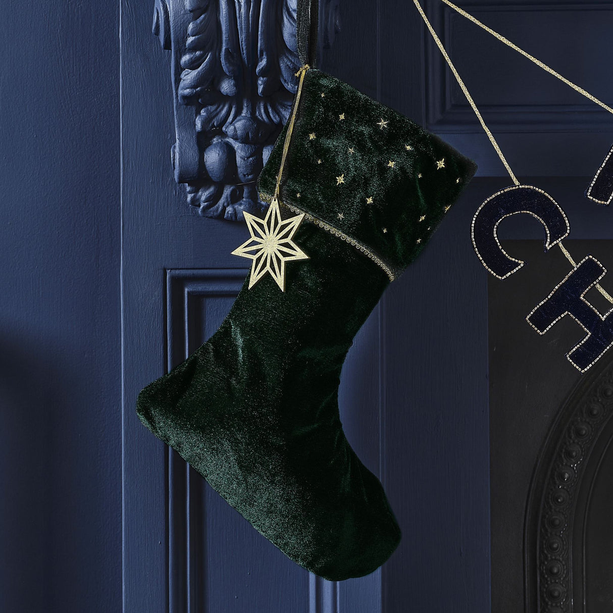 Luxurious green velvet Christmas stocking with embroidered design and wooden gold star charm, 42cm x 25cm.