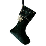 Luxurious green velvet Christmas stocking with gold star charm, perfect for festive decor and eco-friendly celebrations.