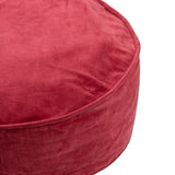 Vibrant red velvet round cushion with elegant piping, perfect for adding style and comfort to any space.