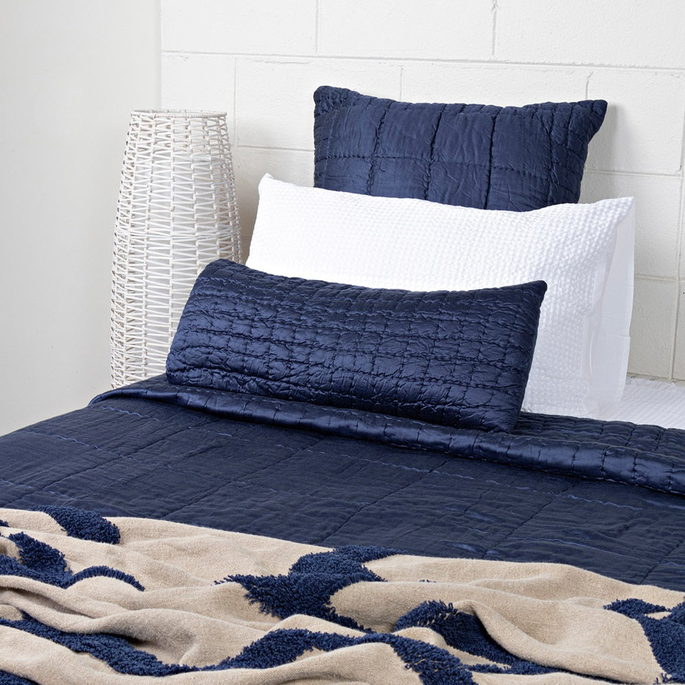 Luxurious indigo Cassius Quilt measuring 220x240cm, hand-quilted with 100% viscose front for elegant bedroom decor.