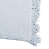 Luxurious stonewashed cotton throw in quarry color with embossed pattern and fringed edges, perfect for cozying up in style.