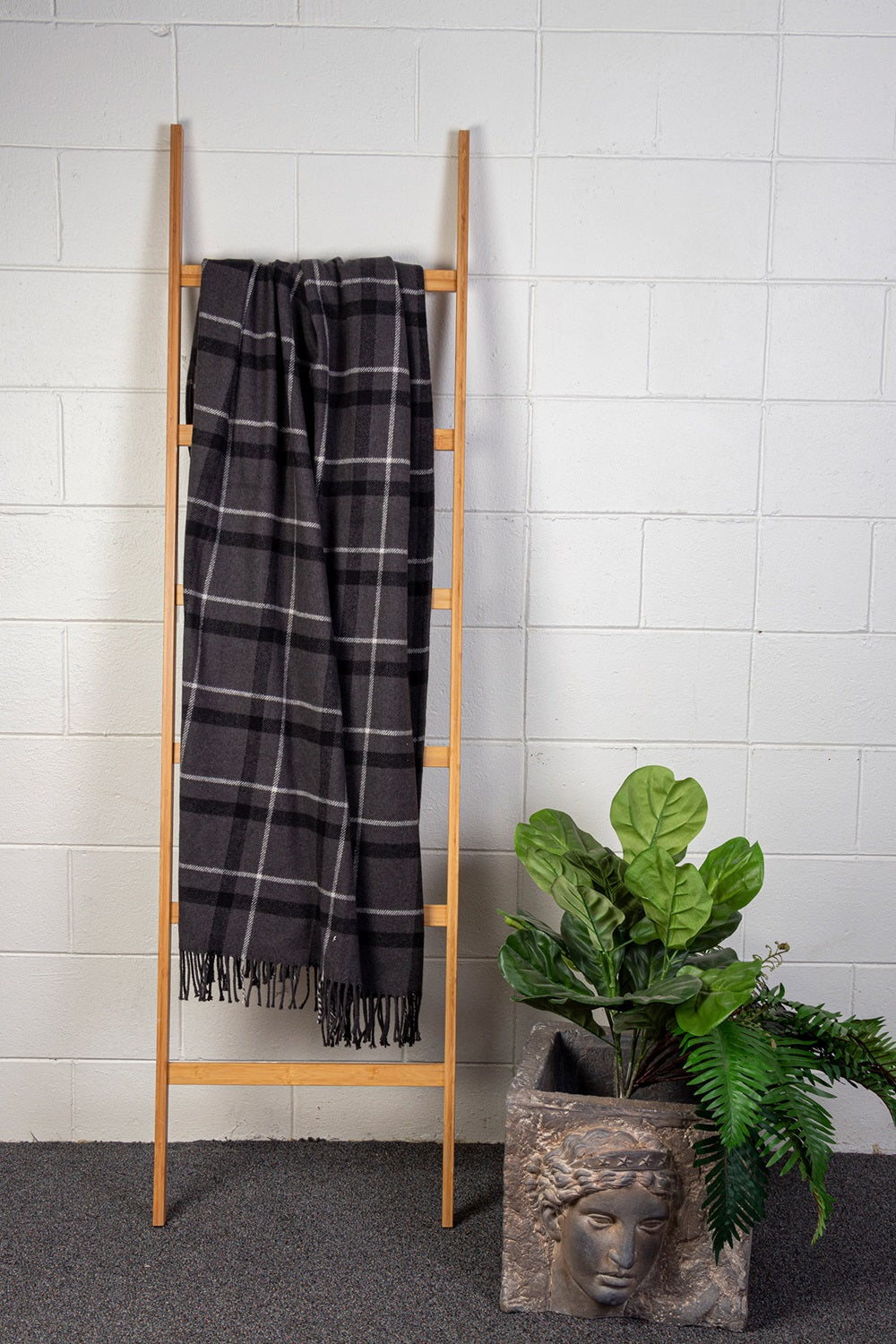 Charcoal and black plaid throw blanket with fringe, measuring 127 x 178 cm, perfect for cozy decor and warmth.