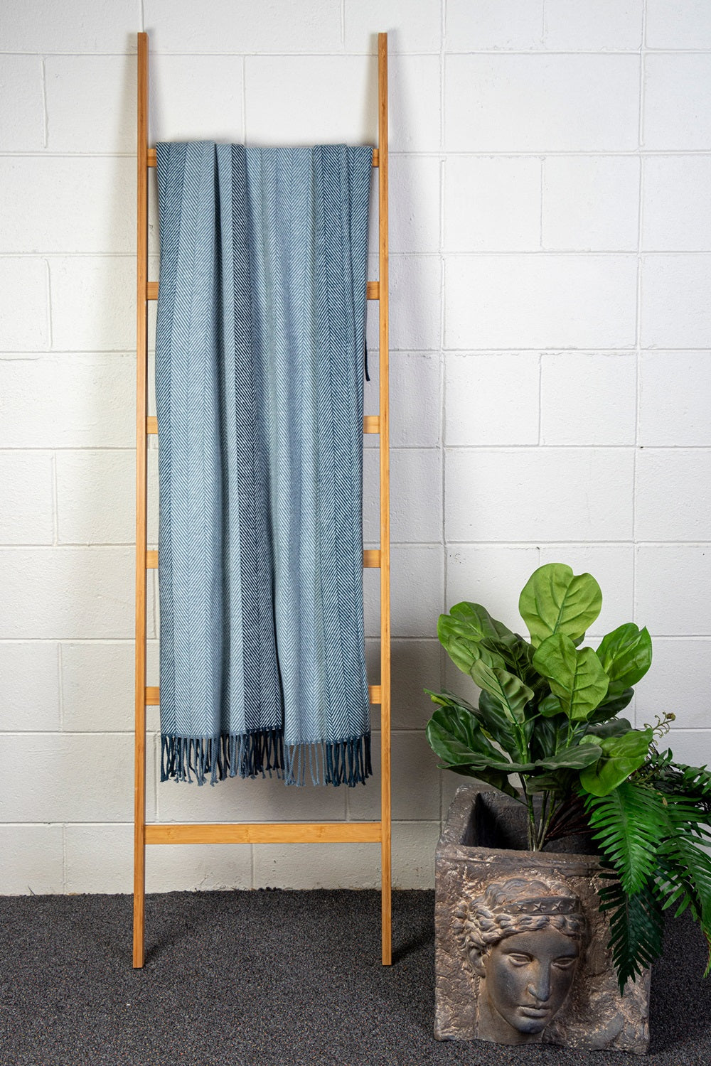 Soft blue herringbone throw with twisted tassel edges, perfect for cozying up or adding style to any space, 127 x 178cm.