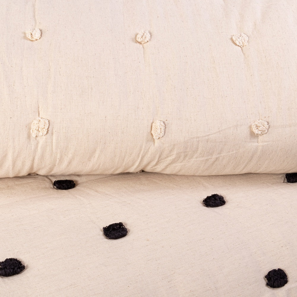 Astrid Queen Quilt in black, featuring playful pom poms, crafted from a cozy cotton/linen blend for stylish comfort.