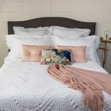 Luxurious Secchi Queen Quilt with crochet lace border, crafted in Portugal, offers style and comfort in cotton, viscose, and silk.