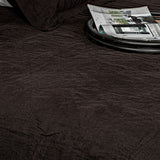 Kyler King Quilt in Asphalt, featured in stone-washed linen, combines style and comfort for a cozy bedroom aesthetic.