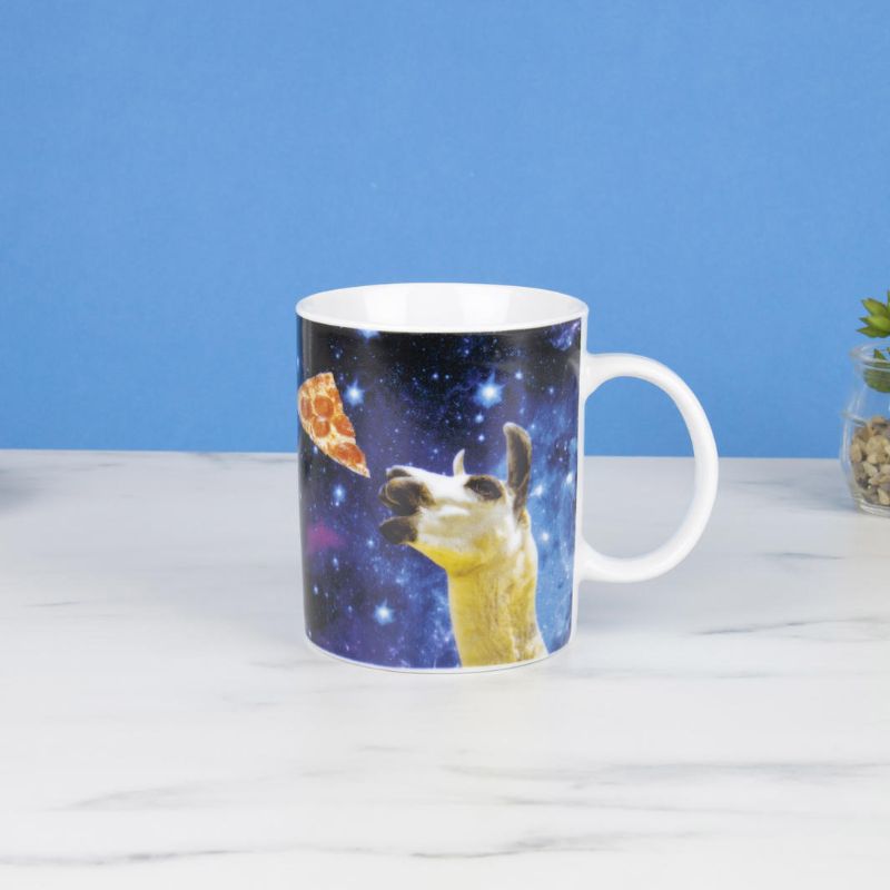 Whimsical ceramic mug featuring a llama floating in space, perfect for coffee lovers and intergalactic dreamers.