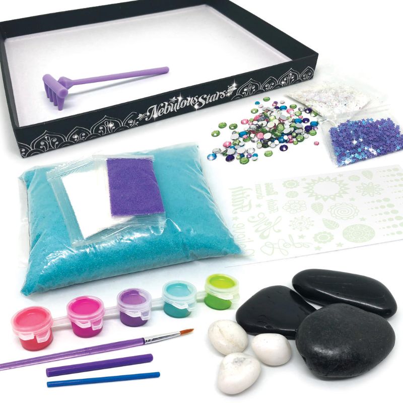 Cosmic Zen Garden Kit featuring a decorative tray, mini rake, colorful sand, and paint for creating serene cosmic landscapes.