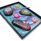 Cosmic Zen Garden Kit with tray, mini rake, natural stones, vibrant paint, and glow-in-the-dark decorations for creative relaxation.